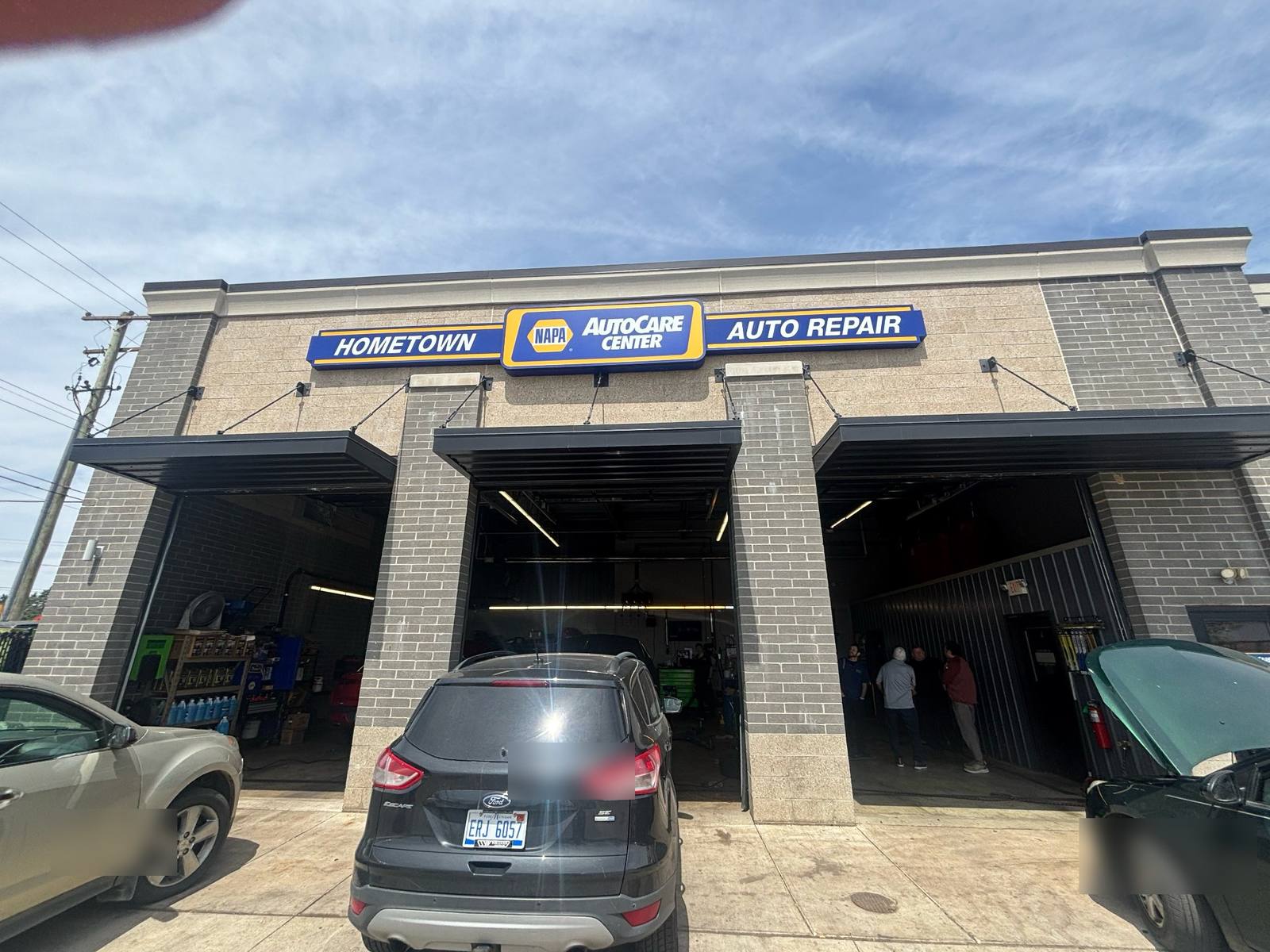 The Hometown NAPA AutoCare Center in Haslett with the service bay doors open